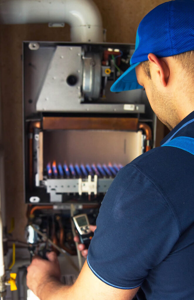 A,Technician,Serving,A,Gas,Boiler,For,Hot,Water,And